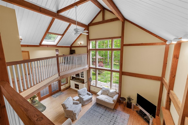 577 Fiddlers Bridge Rd, Staatsburg, NY 12580 - living area with vaulted ceiling, plenty of natural light, a ceiling fan, wood finished floors, and a skylight