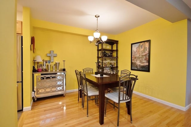 95 Charter Cir Unit 95, Ossining, NY 10562 - dining room featuring a chandelier, light wood-type flooring, and baseboards