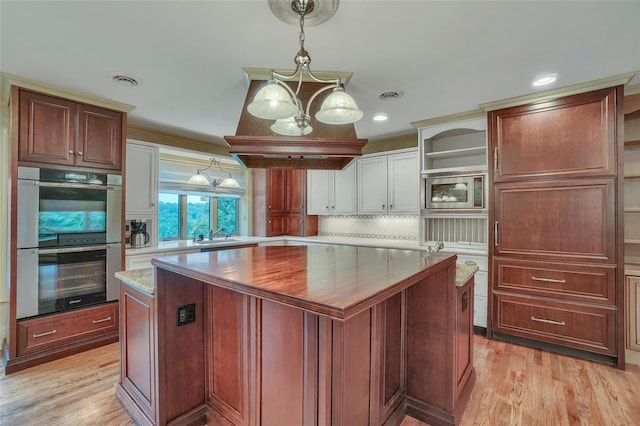 6 Emily Ln, Monroe, NY 10950 - kitchen with open shelves, appliances with stainless steel finishes, a center island, light wood-style floors, and recessed lighting