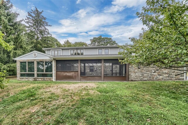 6 Emily Ln, Monroe, NY 10950 - rear view of house featuring a sunroom, stone siding, and a lawn