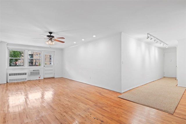 32 Pearsall Unit 3B, Glen Cove, NY 11542 - unfurnished living room with radiator, light wood-type flooring, a ceiling fan, track lighting, and a wall unit AC