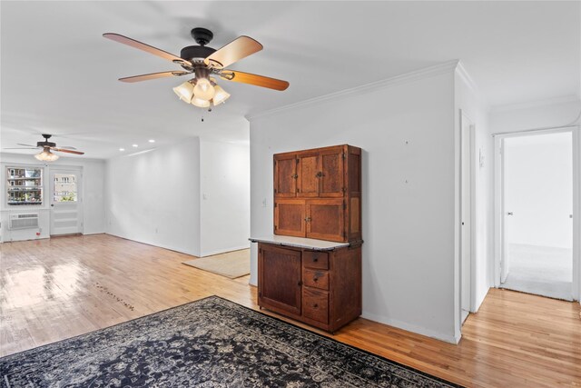 32 Pearsall Unit 3B, Glen Cove, NY 11542 - unfurnished living room with ceiling fan, light wood-style floors, crown molding, baseboards, and a wall mounted air conditioner