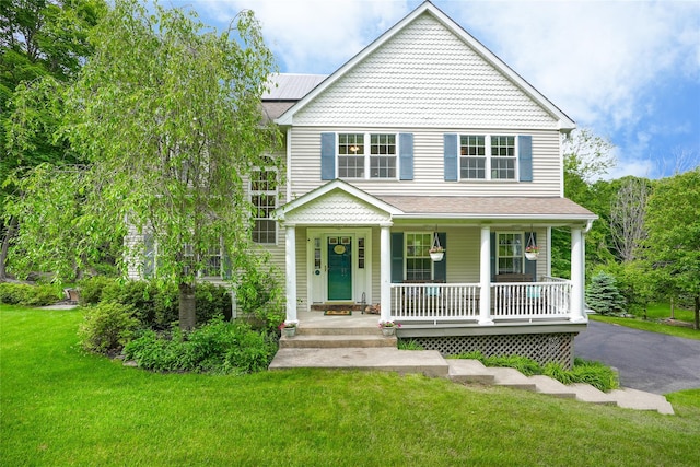 27 Millstream Ct, Pawling, NY 12564 - view of front of home with covered porch, a front lawn, and solar panels
