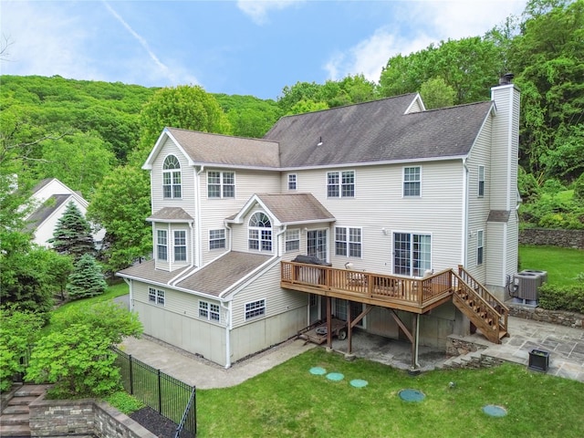 27 Millstream Ct, Pawling, NY 12564 - back of house with a deck, a chimney, a shingled roof, and a patio area