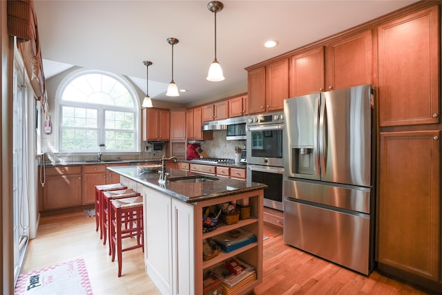 27 Millstream Ct, Pawling, NY 12564 - kitchen with stainless steel appliances, brown cabinets, light wood-style floors, tasteful backsplash, and open shelves