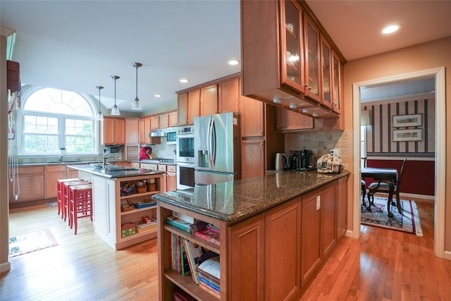 27 Millstream Ct, Pawling, NY 12564 - kitchen featuring appliances with stainless steel finishes, open shelves, light wood finished floors, brown cabinetry, and recessed lighting