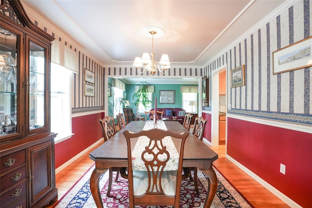 27 Millstream Ct, Pawling, NY 12564 - dining area with a chandelier, healthy amount of natural light, light wood-style floors, wallpapered walls, and crown molding