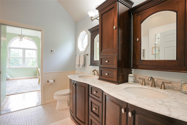 27 Millstream Ct, Pawling, NY 12564 - bathroom with a wainscoted wall, lofted ceiling, double vanity, and wood walls