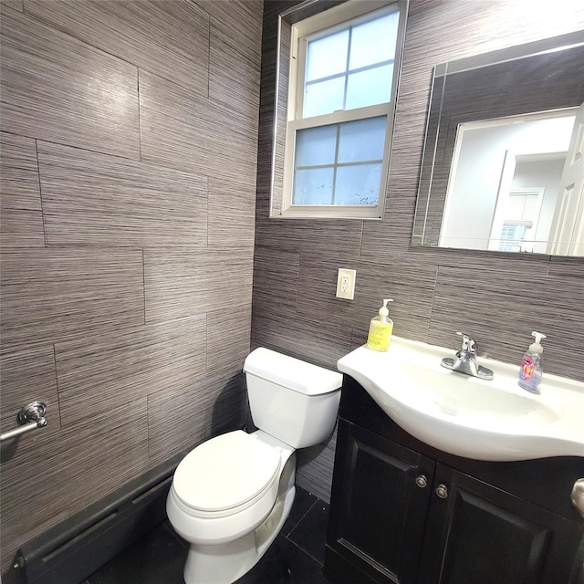 40-19 68th St, Woodside, NY 11377 - bathroom with tile walls, vanity, toilet, and tile patterned floors