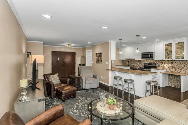99 S Park # 308, Rockville Centre, NY 11570 - living room with dark wood-style flooring, baseboards, ornamental molding, and recessed lighting