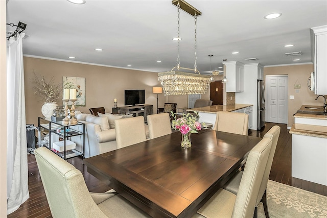 99 S Park # 308, Rockville Centre, NY 11570 - dining space featuring dark wood-style flooring, recessed lighting, crown molding, and a chandelier