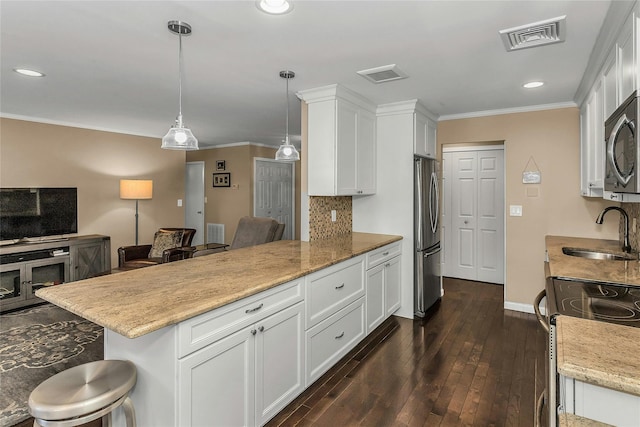 99 S Park # 308, Rockville Centre, NY 11570 - kitchen featuring a sink, appliances with stainless steel finishes, a peninsula, white cabinets, and dark wood-type flooring
