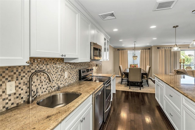 99 S Park # 308, Rockville Centre, NY 11570 - kitchen featuring appliances with stainless steel finishes, a sink, plenty of natural light, dark wood finished floors, and recessed lighting