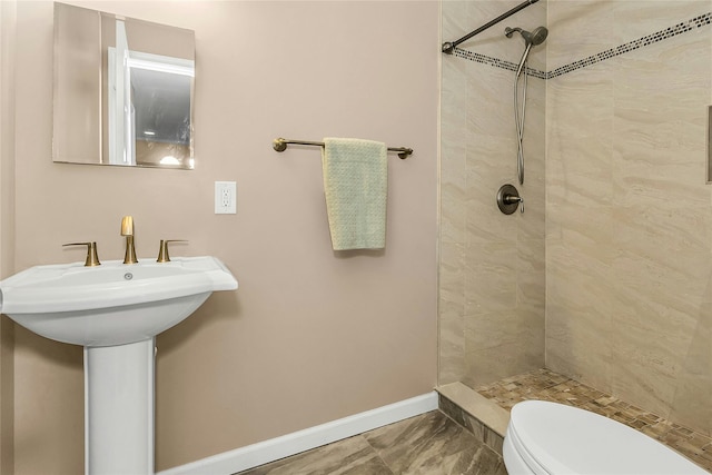 99 S Park # 308, Rockville Centre, NY 11570 - full bathroom featuring tiled shower, baseboards, toilet, marble look tile flooring, and a sink