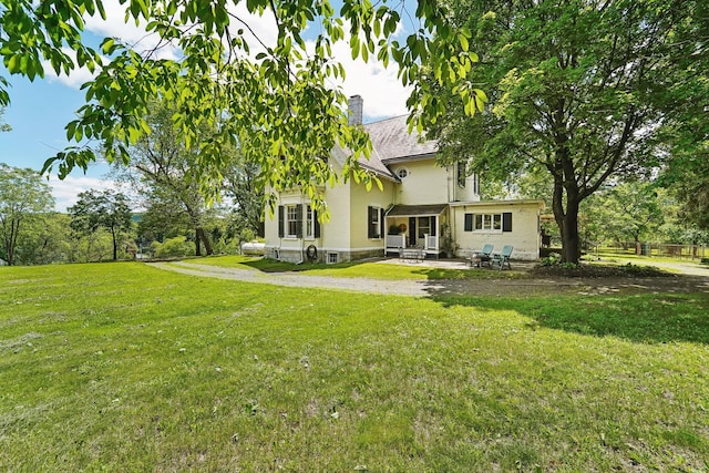 90 Main St, Chester, NY 10918 - back of house with a patio area, a yard, and a chimney