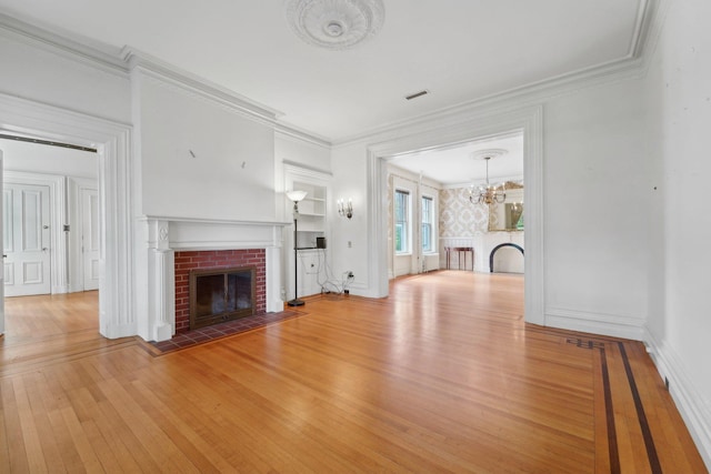 90 Main St, Chester, NY 10918 - unfurnished living room featuring a fireplace, hardwood / wood-style flooring, ornamental molding, a chandelier, and baseboards
