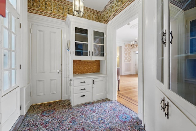 90 Main St, Chester, NY 10918 - mudroom featuring a chandelier, wallpapered walls, a decorative wall, and crown molding
