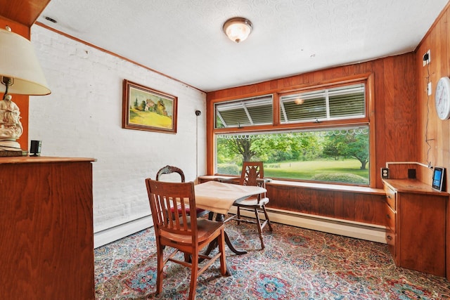 90 Main St, Chester, NY 10918 - dining space with a textured ceiling, wood walls, a baseboard radiator, and a baseboard heating unit