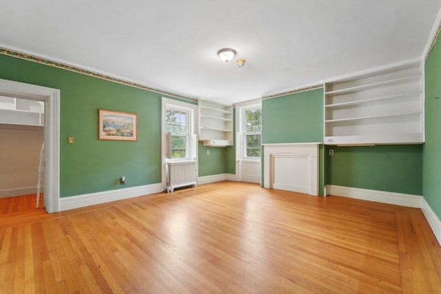 90 Main St, Chester, NY 10918 - unfurnished living room with radiator heating unit, light wood-style flooring, and baseboards