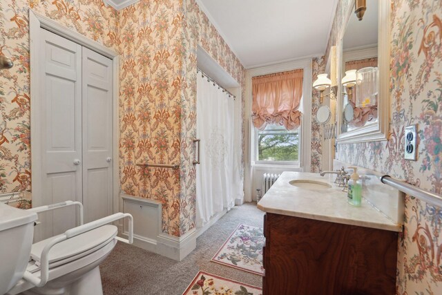 90 Main St, Chester, NY 10918 - full bath featuring wallpapered walls, toilet, vanity, radiator heating unit, and crown molding