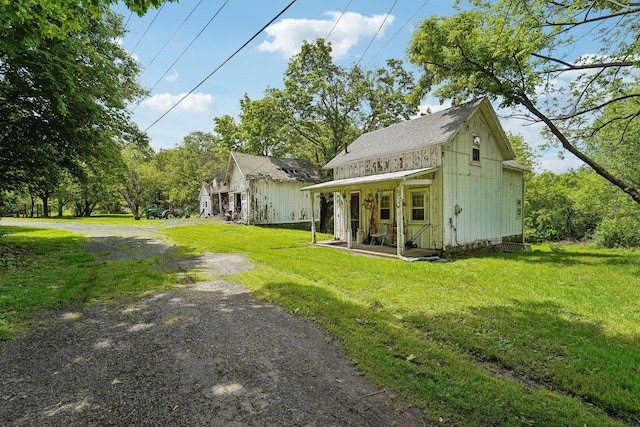 90 Main St, Chester, NY 10918 - view of front of home with a front lawn, a shingled roof, and covered porch