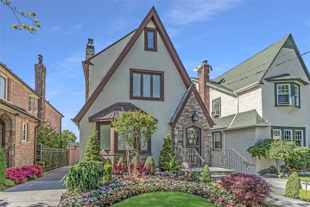 148-03 9th Ave, Whitestone, NY 11357 - tudor home featuring stucco siding, stone siding, and a chimney