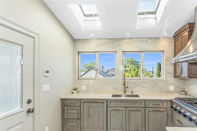 148-03 9th Ave, Whitestone, NY 11357 - kitchen with a skylight, a sink, stainless steel gas stovetop, decorative backsplash, and recessed lighting