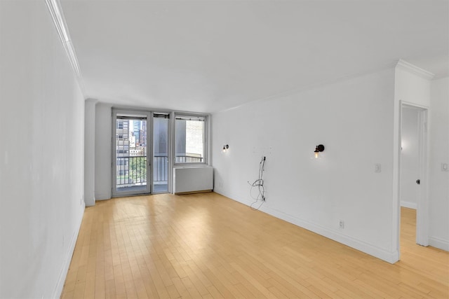 211 E 46th St Unit 14E, New York Manhattan, NY 10017 - unfurnished living room featuring ornamental molding, light wood finished floors, and baseboards