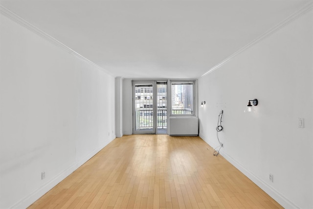 211 E 46th St Unit 14E, New York Manhattan, NY 10017 - unfurnished room with crown molding, light wood-type flooring, and baseboards