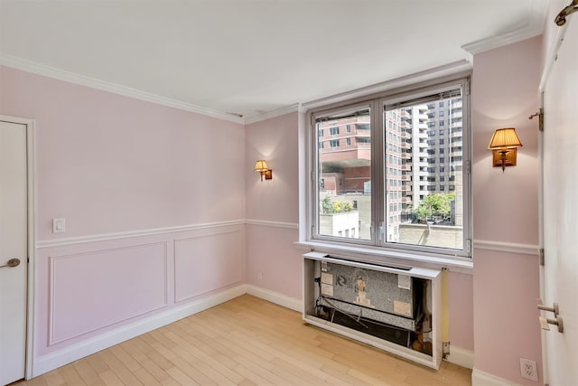 211 E 46th St Unit 14E, New York Manhattan, NY 10017 - empty room featuring healthy amount of natural light, ornamental molding, light wood-style floors, and baseboards