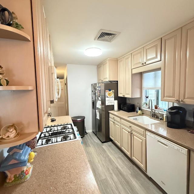 149-45 83rd St, Howard Beach, NY 11414 - kitchen with white appliances, a sink, open shelves, and light countertops