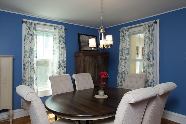 36 Elm St, Pawling, NY 12564 - dining area featuring a chandelier, baseboards, wood finished floors, and ornamental molding
