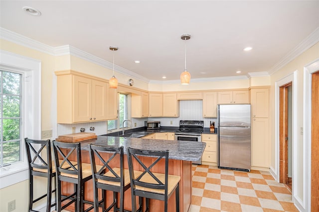 36 Elm St, Pawling, NY 12564 - kitchen featuring appliances with stainless steel finishes, a peninsula, a sink, a kitchen breakfast bar, and decorative light fixtures