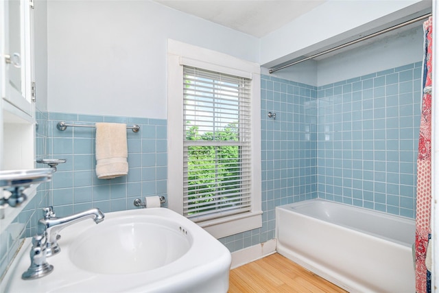 36 Elm St, Pawling, NY 12564 - full bathroom with wood finished floors, a sink, shower / bath combo with shower curtain, and tile walls
