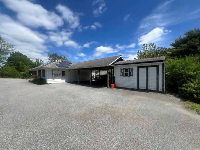420 S Plank Rd, Westtown, NY 10998 - view of front facade featuring a carport, solar panels, and asphalt driveway