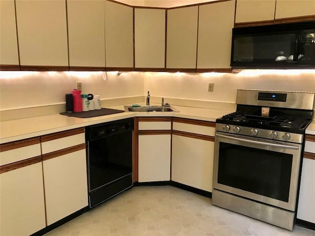 55 Winchester Ave, Peekskill, NY 10566 - kitchen featuring black appliances, a sink, light countertops, and cream cabinets
