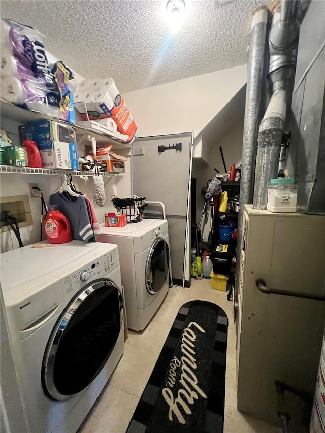 55 Winchester Ave, Peekskill, NY 10566 - laundry room with washing machine and dryer, a textured ceiling, and heating unit