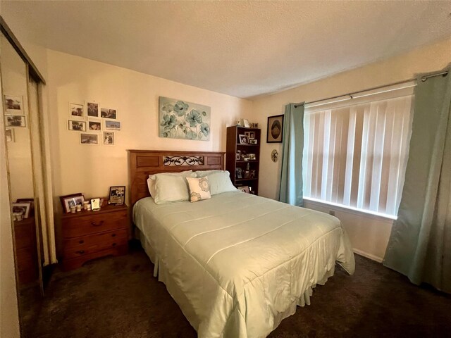 55 Winchester Ave, Peekskill, NY 10566 - bedroom with dark carpet and a textured ceiling