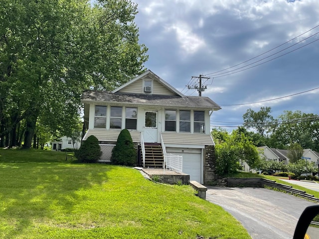 193 Bert Crawford Rd, Middletown, NY 10940 - view of front of home with asphalt driveway, a garage, a front yard, roof with shingles, and stone siding