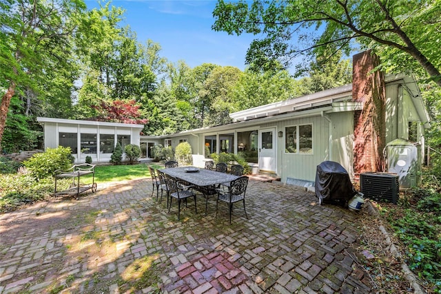 6 Harbor Hill Dr, Lloyd Harbor, NY 11743 - view of patio with outdoor dining area, a sunroom, and central air condition unit