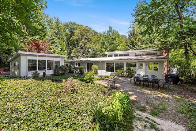 6 Harbor Hill Dr, Lloyd Harbor, NY 11743 - back of house featuring a sunroom and a patio