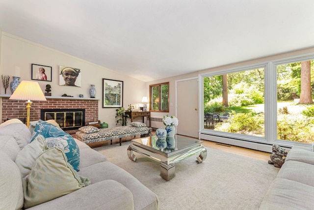 6 Harbor Hill Dr, Lloyd Harbor, NY 11743 - living room with vaulted ceiling, wood finished floors, radiator heating unit, a fireplace, and a baseboard heating unit