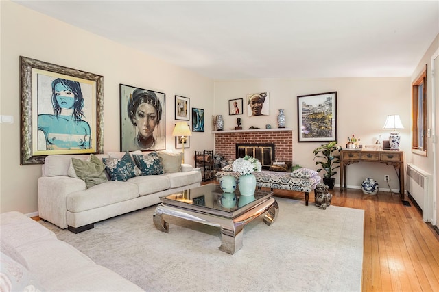 6 Harbor Hill Dr, Lloyd Harbor, NY 11743 - living area featuring radiator heating unit, wood-type flooring, a brick fireplace, and baseboards