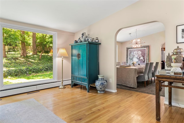 6 Harbor Hill Dr, Lloyd Harbor, NY 11743 - living room featuring arched walkways, light wood-style floors, and a chandelier