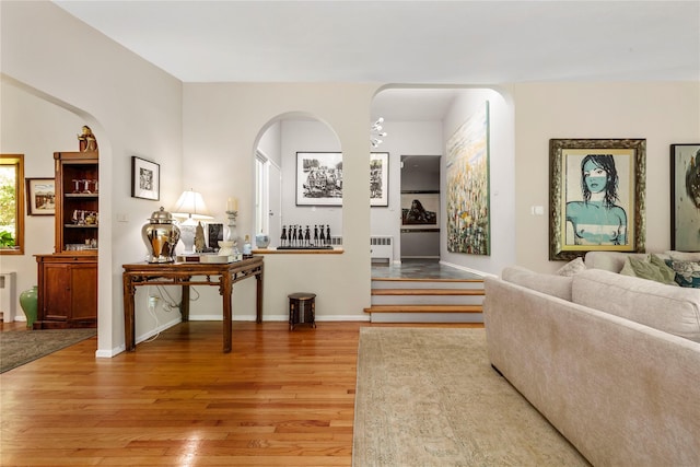 6 Harbor Hill Dr, Lloyd Harbor, NY 11743 - living area with radiator heating unit, light wood-type flooring, baseboards, and arched walkways