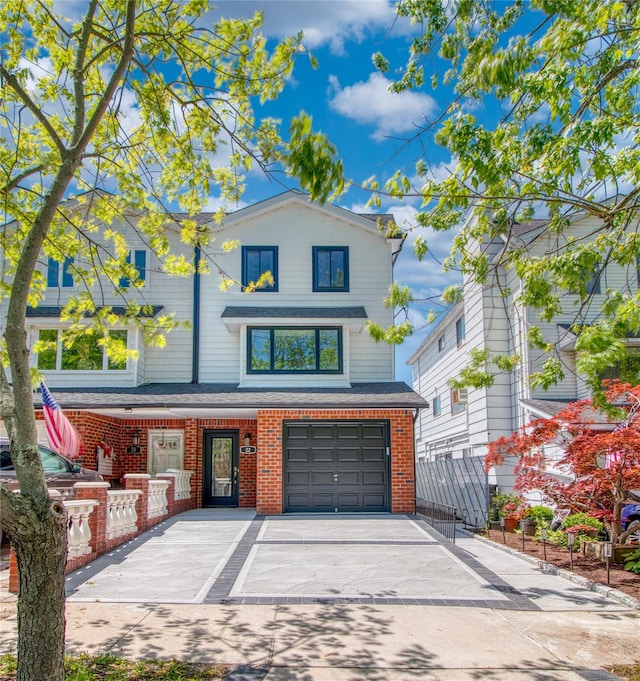 22 May Pl, Staten Island, NY 10312 - view of front of house with brick siding, driveway, and a garage