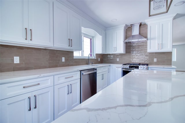 22 May Pl, Staten Island, NY 10312 - kitchen with appliances with stainless steel finishes, wall chimney exhaust hood, a sink, white cabinetry, and light stone countertops