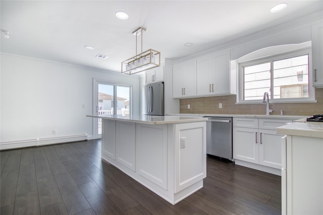 22 May Pl, Staten Island, NY 10312 - kitchen with appliances with stainless steel finishes, light countertops, a sink, white cabinets, and crown molding