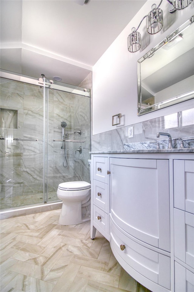 22 May Pl, Staten Island, NY 10312 - bathroom with tile walls, vanity, toilet, a shower stall, and wainscoting