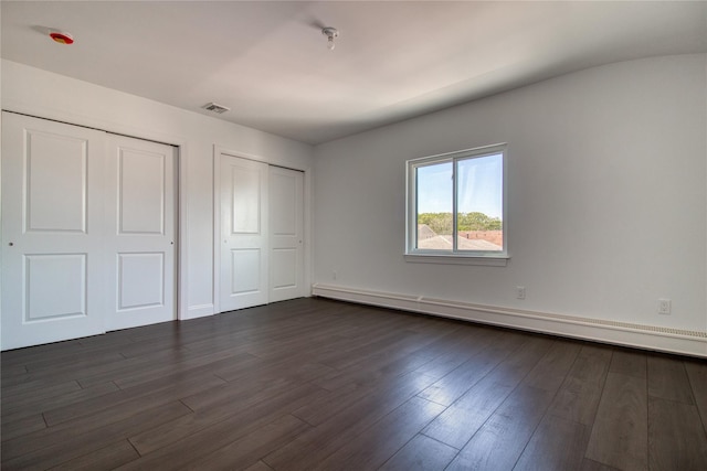 22 May Pl, Staten Island, NY 10312 - unfurnished bedroom featuring a baseboard heating unit, dark wood-type flooring, multiple closets, and baseboards